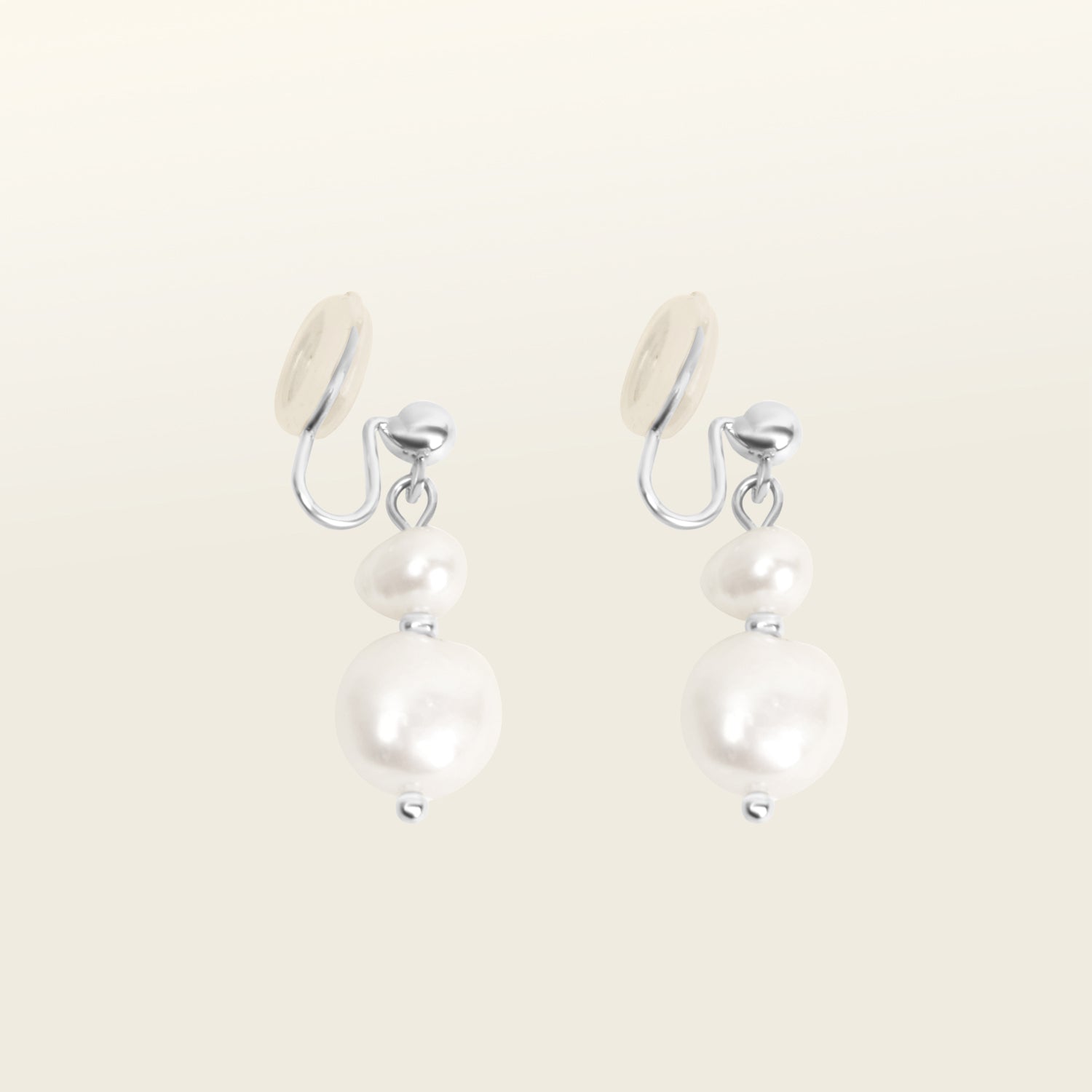 Image of the Silver Plated Brass Duo Pearl Clip-On Earrings features a mosquito coil clip-on design, making it ideal for all ear types including those with thick/large, sensitive, small/thin, and stretched/healing ears. These earrings comfortably allow for up to 24 hours of wear and have a medium secure hold with adjustable padding. The freshwater pearls used in these earrings may vary slightly in size and colour.
