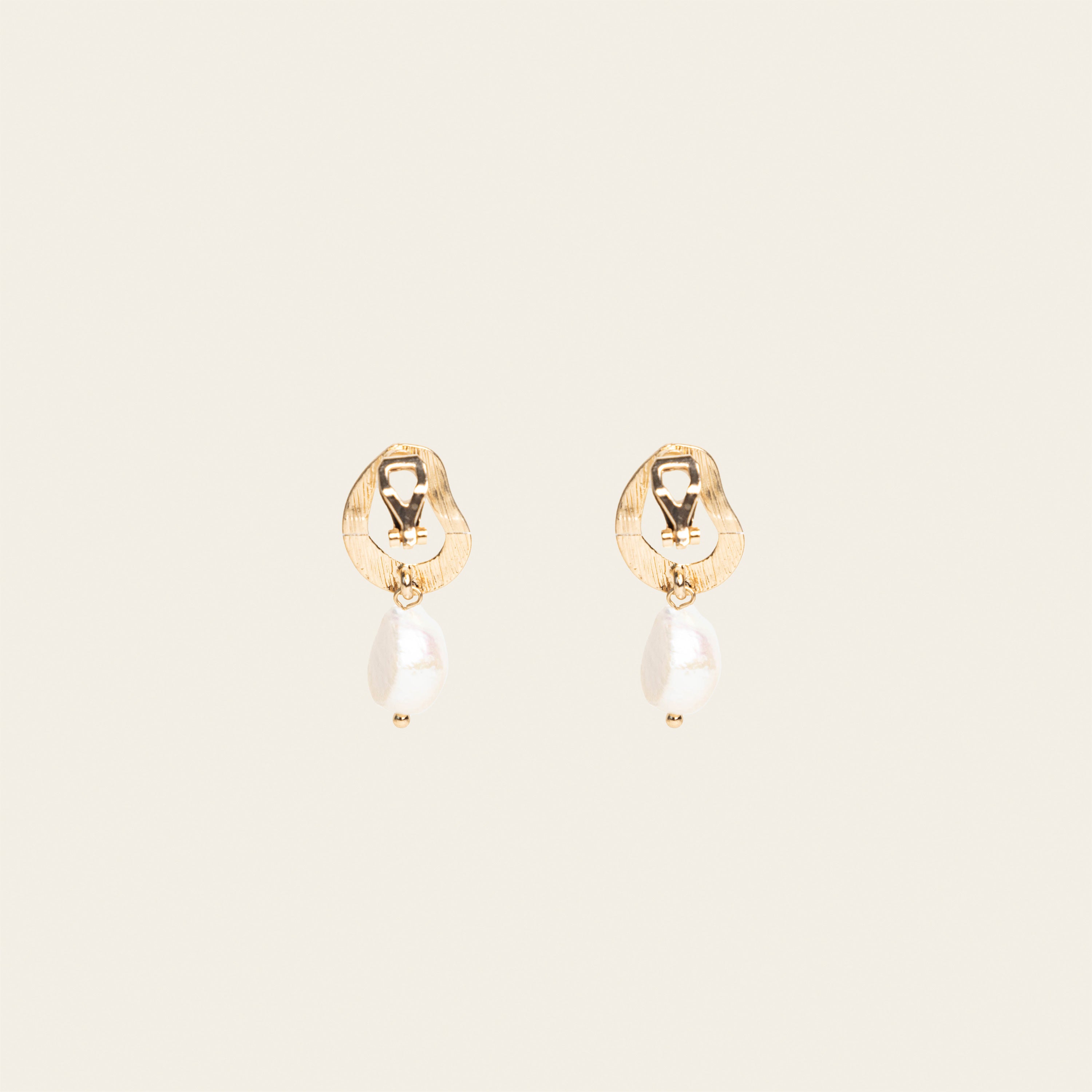 Image of the Ella Clip On Earrings. Perfect for sensitive or stretched ears, they provide a 24-hour hold and adjustable fit for unmatched comfort. Effortlessly add a touch of elegance to your look.