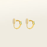Image of the Emerald Pavé Huggie Clip-On Earrings features a closure type of mosquito coil clip-on earrings. They are suitable for all types of ear shapes and sizes, and are comfortable to wear for up to 24 hours. The hold strength is medium, allowing you to gently adjust the padding forward once on the ear. Crafted with 18k gold plated metal alloy and cubic zirconia, these earrings are non-tarnish and water-resistant.