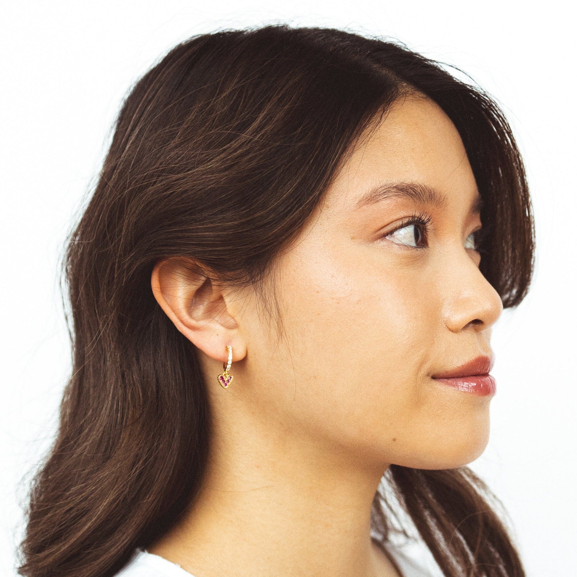 A model wearing the Emma Clip On Earrings, the perfect accessory for any ear! These expertly designed clip-ons are ideal for all ear types and offer a secure hold for up to 24 hours. Made for those with sensitive, stretched, or keloid prone ears, these earrings provide medium strength without compromising on style.