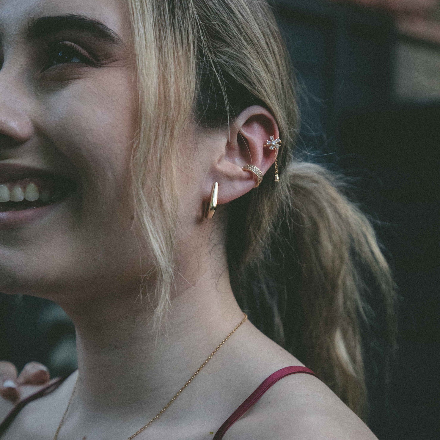 Model showcasing our 18K Gold Plated Ear Cuff with Cubic Zirconia. Water-resistant and non-tarnish for all-day wear.  Gentle squeeze for the perfect fit on any ear type.