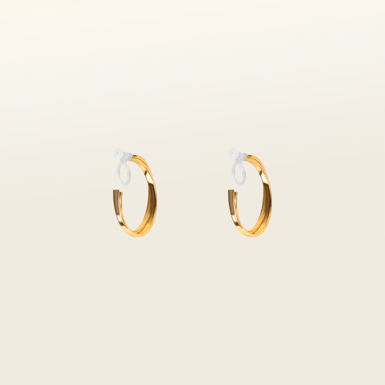 Image of the Gold Cassie Hoop Clip-On Earrings feature a resin closure, making them ideal for all ear types, including thick/large ears, sensitive ears, small/thin ears, and stretched/healing ears. On average, pairs are comfortably worn for 8-12 hours with a medium secure hold, and they are not adjustable. This item is sold as a single pair and is also available in Silver. The earrings are constructed with gold-tone metal alloy.