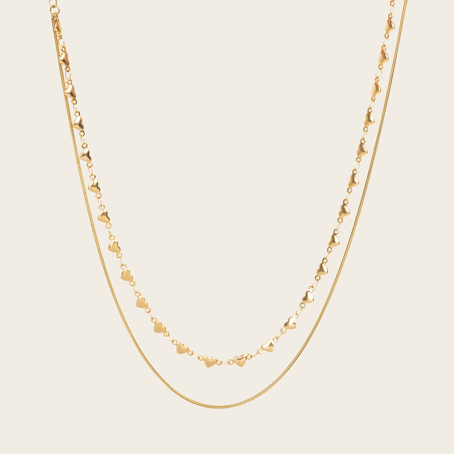 Image of the Heart Chain Double Layered Necklace is crafted from 14K Gold Plated Stainless Steel, which is water resistant and non-tarnishing. The necklace can be adjusted for a perfect fit. Please Note: This product is one necklace.