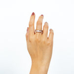 A model wearing the Jamie Ring boasts 18K gold plating over durable stainless steel for unrivaled resistance to tarnishing and water damage. Its sleek and timeless appeal is heightened by the non-adjustable design, making it the perfect single ring for any occasion.