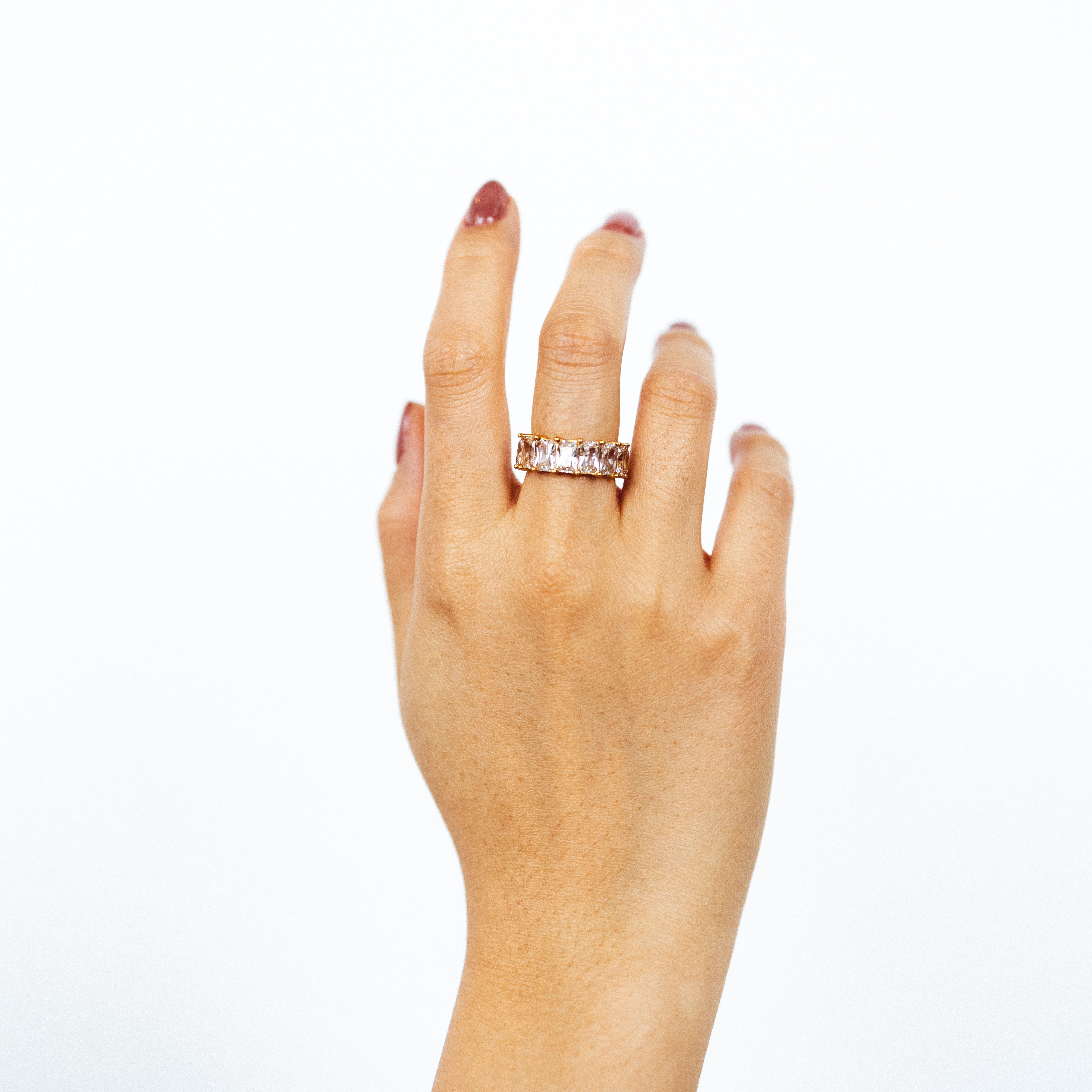 A model wearing the Jamie Ring boasts 18K gold plating over durable stainless steel for unrivaled resistance to tarnishing and water damage. Its sleek and timeless appeal is heightened by the non-adjustable design, making it the perfect single ring for any occasion.