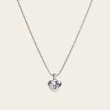 A model wearing the Jude Heart Necklace is expertly crafted from Stainless Steel, resulting in a durable and water-resistant accessory. Its adjustable chain allows for a customized fit. Elegant and functional, this single necklace is a must-have for any jewelry collection.