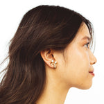 A model wearing the Lacey Clip On Earrings: the perfect solution for non-pierced ears. These stylish and versatile earrings provide a medium strength hold for up to 24 hours, making them ideal for all day wear. They are adjustable for a perfect fit and suitable for both sensitive and stretched ears.