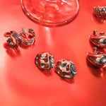 A model wearing the Amaya Clip On Earrings in Silver feature a secure padded clip-on closure type, making them suitable for all ear types.The average comfortable wear duration is 8-12 hours, and the Copper Alloy construction ensures a reliable and secure hold. The item is sold as one pair; adjustable rubber padding is included.