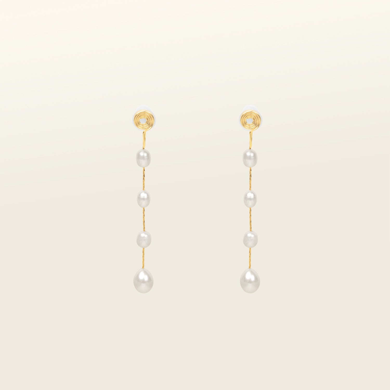 Image of the Lune Pearl Clip-On Earrings in Gold feature a unique, secure mosquito coil clasp. They are ideal for all ear types, from thick and large ears to sensitive and small. With medium hold strength, the earrings can be comfortably worn up to 24 hours and easily adjusted. Crafted with freshwater pearls, each pair may display natural variations in size and color. Materials include freshwater pearl and 18K gold-plated stainless steel.