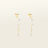 Image of the Lune Pearl Clip-On Earrings in Gold feature a unique, secure mosquito coil clasp. They are ideal for all ear types, from thick and large ears to sensitive and small. With medium hold strength, the earrings can be comfortably worn up to 24 hours and easily adjusted. Crafted with freshwater pearls, each pair may display natural variations in size and color. Materials include freshwater pearl and 18K gold-plated stainless steel.
