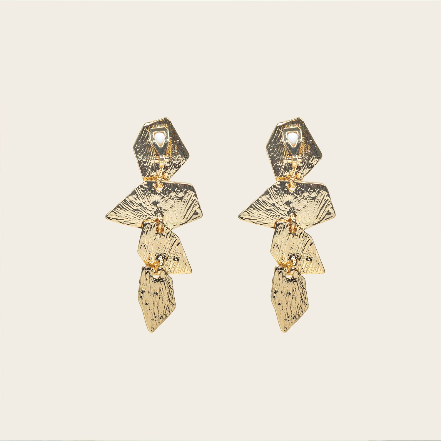 Image of the Manhattan Drop Clip On Earrings in Gold provide a secure and comfortable fit for any ear type. The padded clip-on design features a zinc and copper alloy construction, and lasts approximately 8-12 hours. As the earring pairs are non-adjustable, each purchase contains a single pair.
