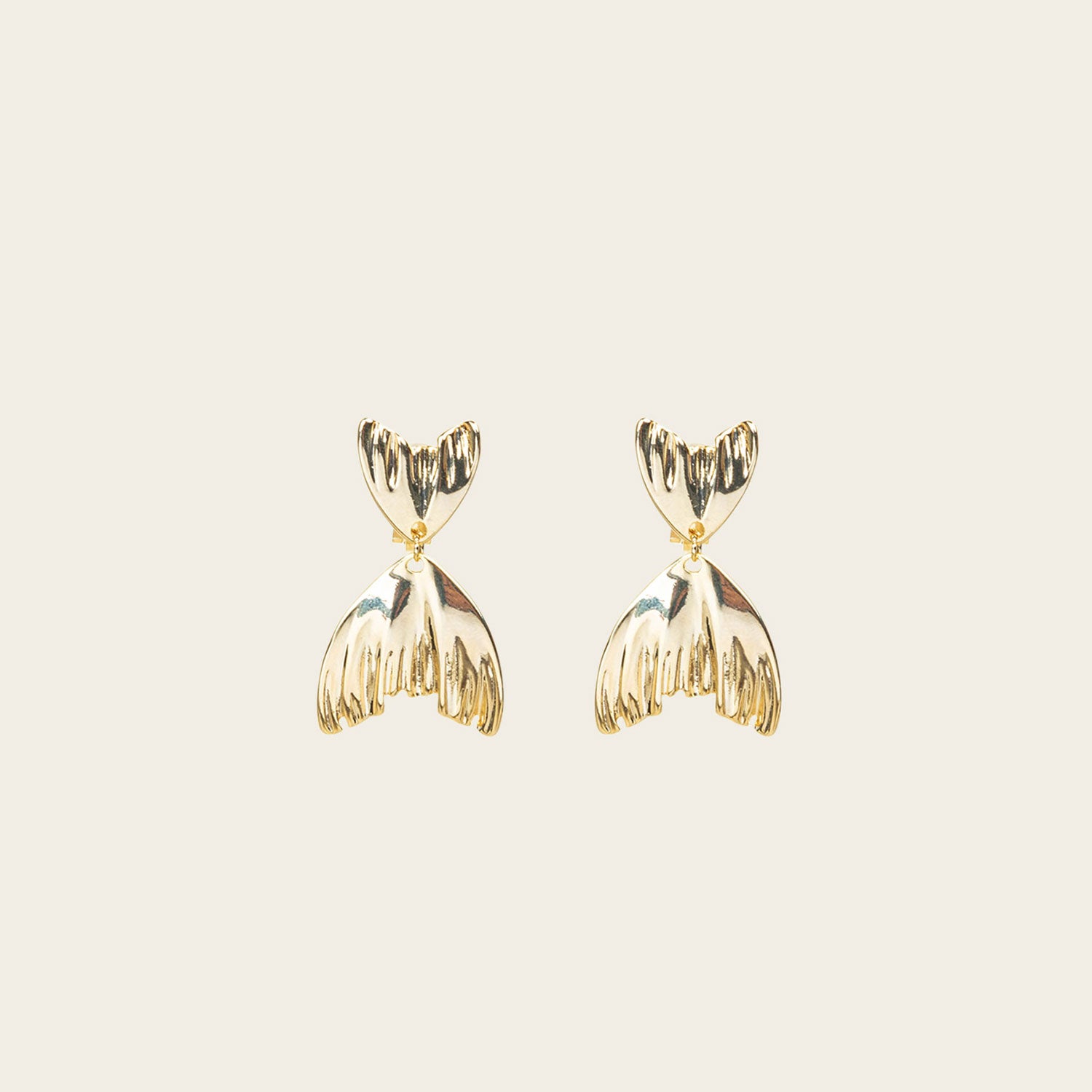 Image of the Mermaid Tail Clip On Earrings in Gold are perfect for all ear types including thick/large ears, sensitive ears, small/thin ears, and stretched/healing ears. With a zinc alloy body, these earrings offer a secure hold of up to 8-12 hours and come with removable rubber padding. Please note, item is only one pair.
