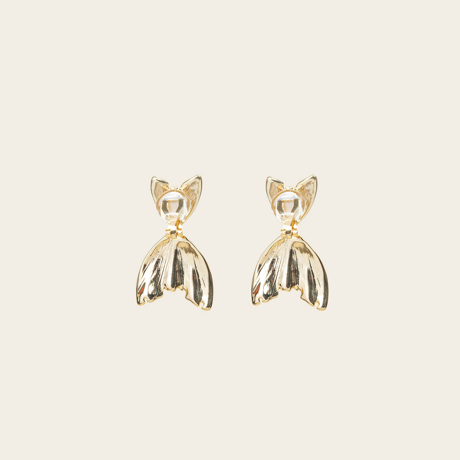 Image of the Mermaid Tail Clip On Earrings in Gold are perfect for all ear types including thick/large ears, sensitive ears, small/thin ears, and stretched/healing ears. With a zinc alloy body, these earrings offer a secure hold of up to 8-12 hours and come with removable rubber padding. Please note, item is only one pair.