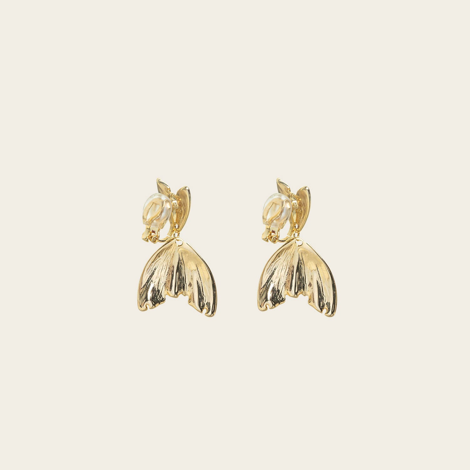 Image of the Mermaid Tail Clip On Earrings in Gold are perfect for all ear types including thick/large ears, sensitive ears, small/thin ears, and stretched/healing ears. With a zinc alloy body, these earrings offer a secure hold of up to 8-12 hours and come with removable rubber padding. Please note, item is only one pair.