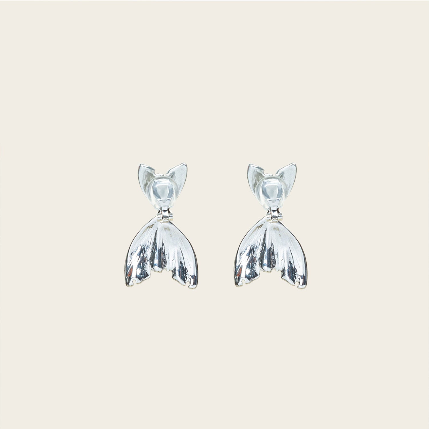Image of the Mermaid Tail Clip On Earrings crafted in Silver Tone Zinc Alloy provide a secure hold for 8 to 12 hours. Padded Clip-On style is ideal for all ear types, and the earrings come as one pair with removable rubber padding. No adjustments possible.