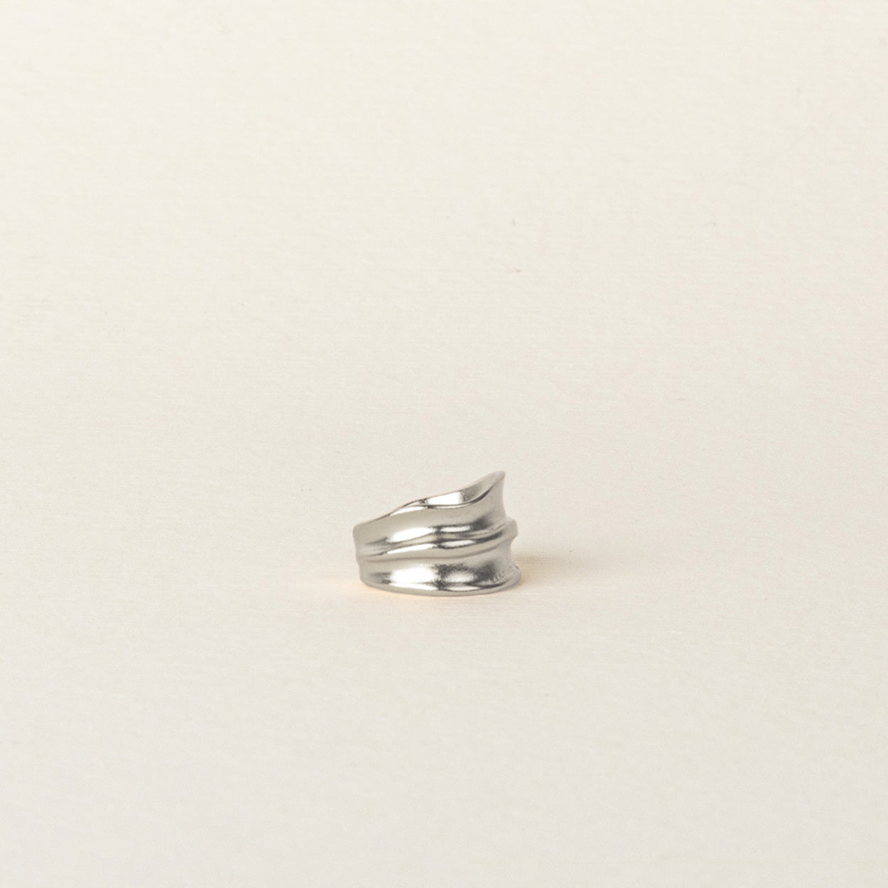 Image of the Mona Ear Cuff in Silver is designed for all ear types, providing a comfortable, medium secure hold for up to 24 hours. It features the ability to adjust with gentle squeezing, crafted with 925 Sterling Silver in one piece.