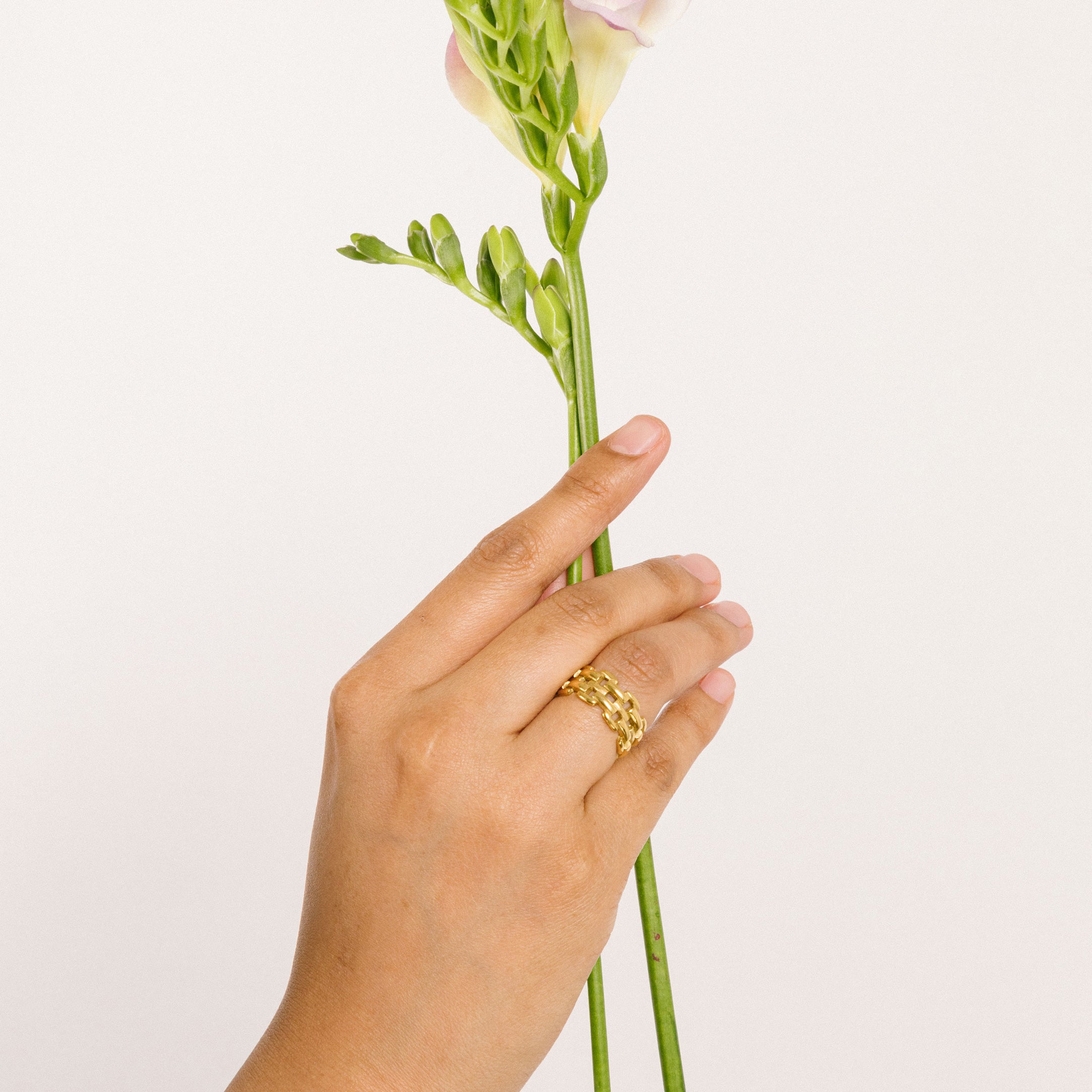 A model wearing the Panther Chain Ring affords no adjustability and is composed of 18K Gold Plated over Stainless Steel, offering a Non-Tarnish and Water-Resistant finish. Please note, item is one ring only.