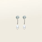 Image of the Pearl Pavé Huggie Clip-On Earrings in Silver feature a mosquito coil clip-on closure and are suitable for all ear types including thick/large, sensitive, small/thin and stretched/healing ears. For a secure but comfortable hold, they can be worn for up to 24 hours and can be adjusted with a gentle squeeze of the padding. Made with Freshwater Pearls and Silver Plated Brass, each pair has natural variations in size and colour.