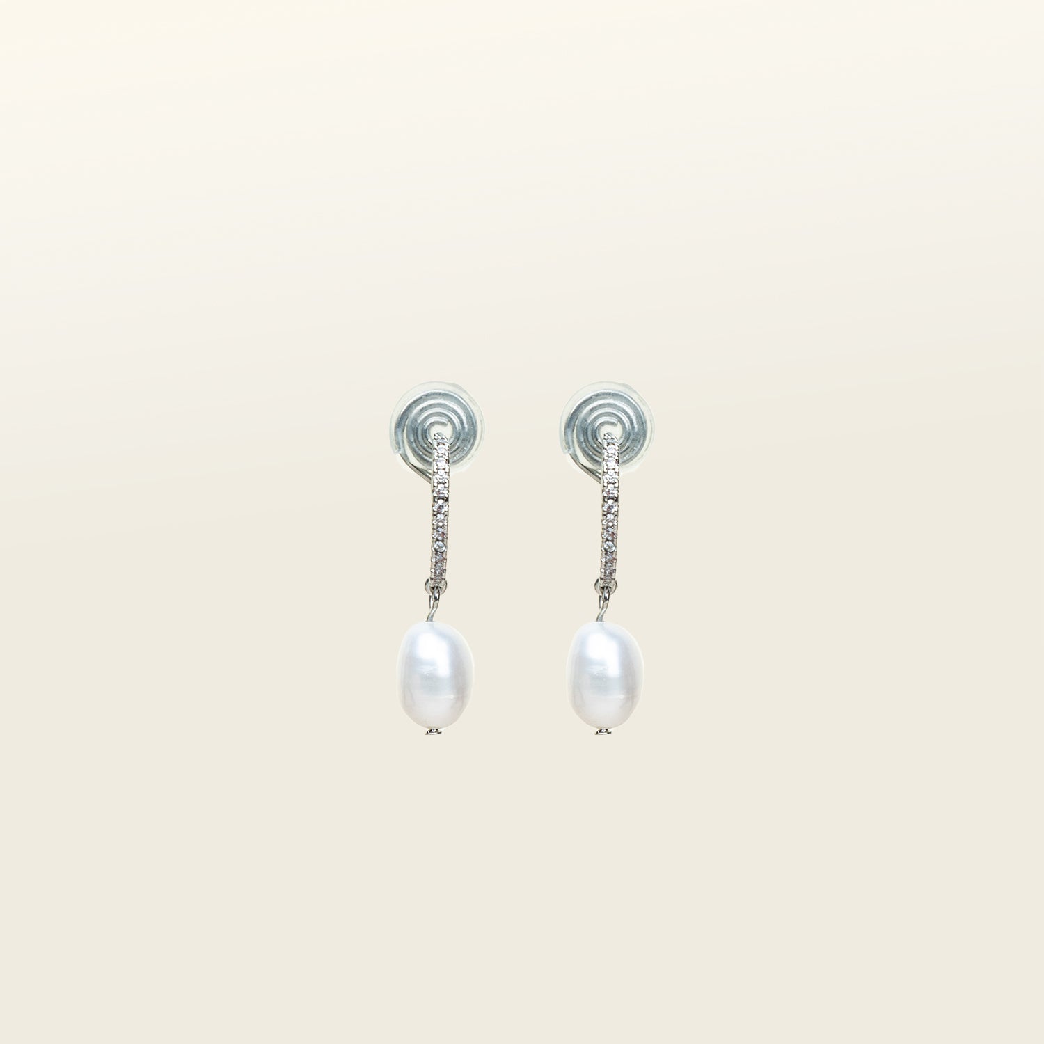 Image of the Pearl Pavé Huggie Clip-On Earrings in Silver feature a mosquito coil clip-on closure and are suitable for all ear types including thick/large, sensitive, small/thin and stretched/healing ears. For a secure but comfortable hold, they can be worn for up to 24 hours and can be adjusted with a gentle squeeze of the padding. Made with Freshwater Pearls and Silver Plated Brass, each pair has natural variations in size and colour.