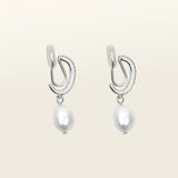 Image of the Pearl Pavé Huggie Clip-On Earrings in Silver feature a mosquito coil clip-on closure and are suitable for all ear types including thick/large, sensitive, small/thin and stretched/healing ears. For a secure but comfortable hold, they can be worn for up to 24 hours and can be adjusted with a gentle squeeze of the padding. Made with Freshwater Pearls and Silver Plated Brass, each pair has natural variations in size and colour.
