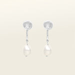 Image of the Pearl Pavé Huggie Clip-On Earrings in Silver feature a mosquito coil clip-on closure and are suitable for all ear types including thick/large, sensitive, small/thin and stretched/healing ears. For a secure but comfortable hold, they can be worn for up to 24 hours and can be adjusted with a gentle squeeze of the padding. Made with Freshwater Pearls and Silver Plated Brass, each pair has natural variations in size and colour.