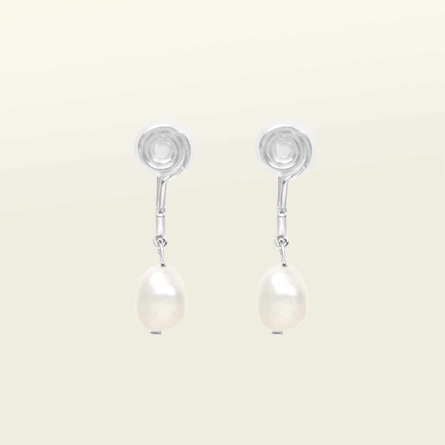 Image of the Pearl Pavé Huggie Clip-On Earrings in Silver feature a mosquito coil clip-on closure and are suitable for all ear types including thick/large, sensitive, small/thin and stretched/healing ears. For a secure but comfortable hold, they can be worn for up to 24 hours and can be adjusted with a gentle squeeze of the padding. Made with Freshwater Pearls and Silver Plated Brass, each pair has natural variations in size and colour.