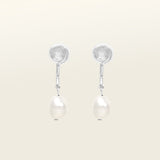 Image of the Pearl Pavé Huggie Clip-On Earrings in Silver feature a mosquito coil clip-on closure and are suitable for all ear types including thick/large, sensitive, small/thin and stretched/healing ears. For a secure but comfortable hold, they can be worn for up to 24 hours and can be adjusted with a gentle squeeze of the padding. Made with Freshwater Pearls and Silver Plated Brass, each pair has natural variations in size and colour.