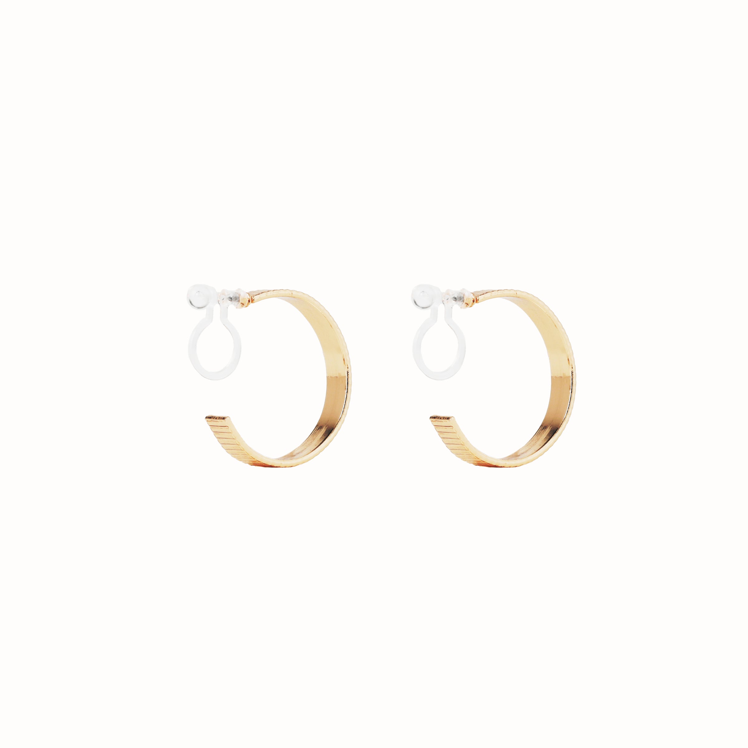 Image of the Pleated Hoop Clip On Earrings in Gold offer a resin clip-on closure for a secure and comfortable fit for a variety of ear sizes and sensitivities. With an average wear duration of 8-12 hours, these earrings are perfect for all-day wear. Please note that this listing is for a single pair.