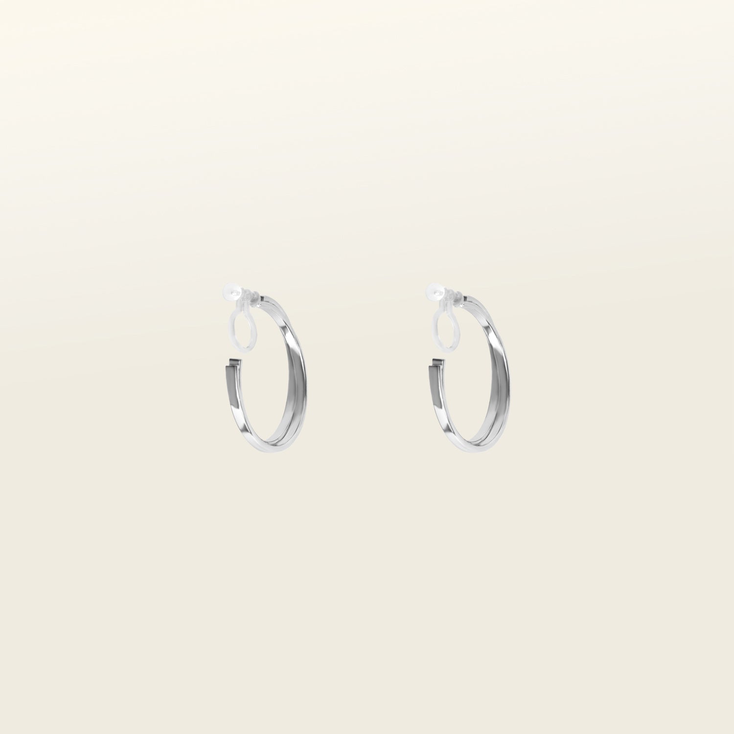 Image of the Silver Cassie Hoop Clip-On Earrings have a resin clip-on closure type and are suitable for all ear types, from thick/large ears to small/thin ears and stretched/healing ears. On average, comfortably wear for 8-12 hours, with a medium secure hold. Unfortunately, these earrings are unable to be adjusted. Offered in Silver Tone metal alloy, the earrings also come in Gold.