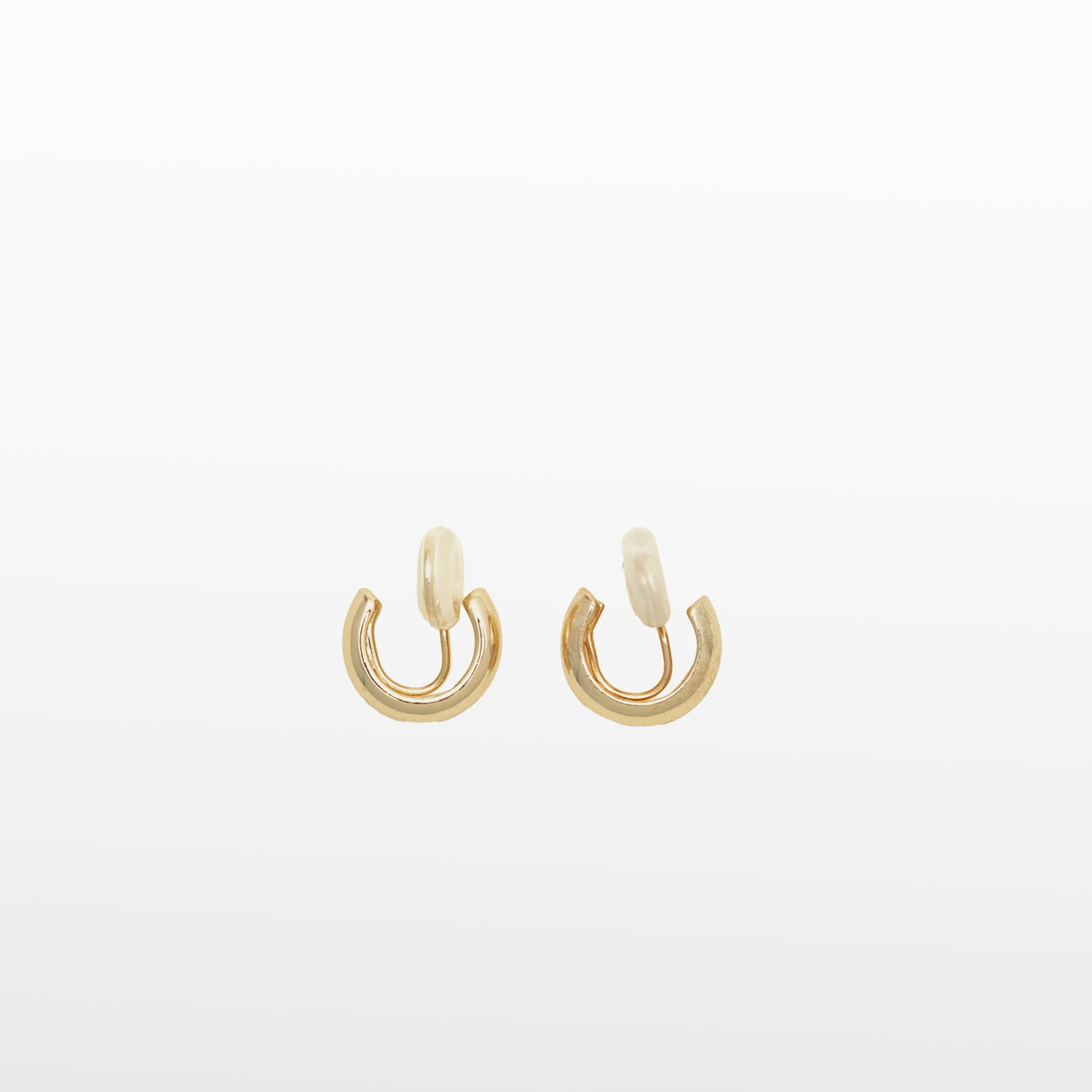 Image of the Small Hoop Clip On Earrings in Gold feature a mosquito coil closure for a secure hold of up to 24 hours. The earrings are designed to fit any ear type, including thick or large, sensitive, small or thin, and stretched or healing ears. They possess a medium secure hold and can be adjusted to fit the wearer's ear size, simply by gently squeezing the inner padding forward. Crafted from gold tone plated copper alloy, each package contains one pair.