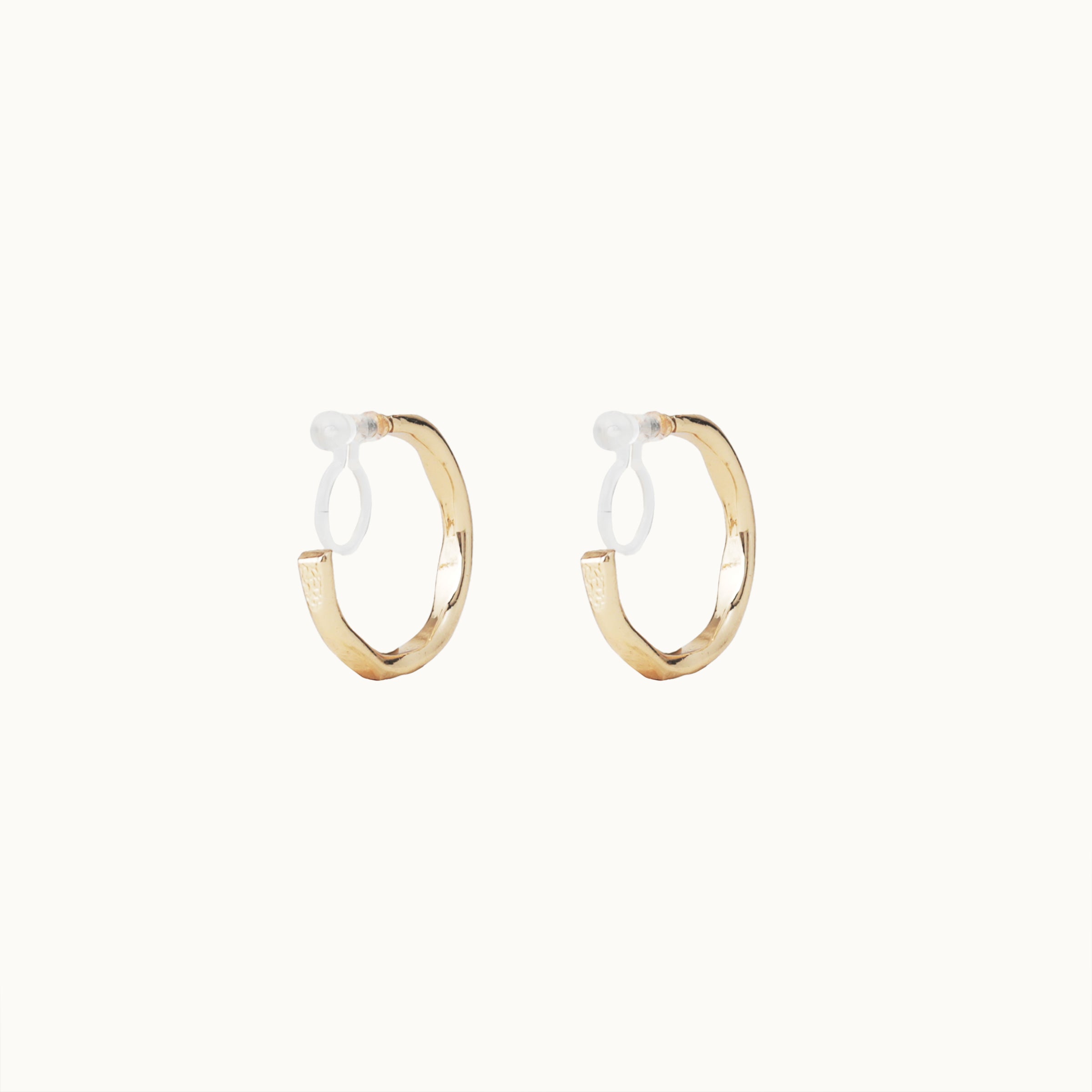 Image of the Smith Hoop Clip On Earrings in Gold, perfect for all ear sizes. With a resin clip-on closure and medium secure hold, these earrings provide comfort for 8-12 hours. Whether you have thick, large, or sensitive ears, these earrings are a must-have! Note: No adjustments possible and one pair only.