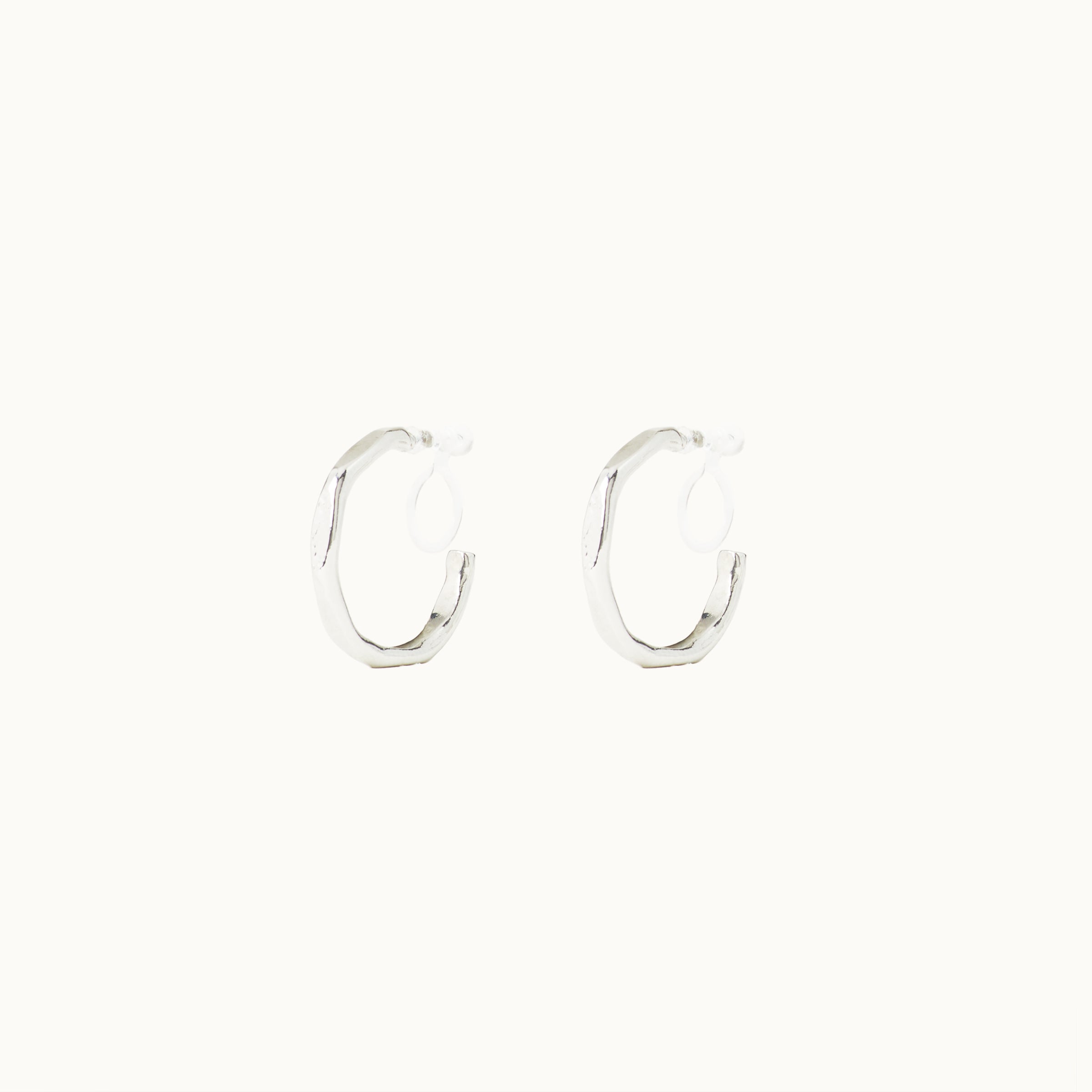 Image of the Smith Hoop Clip On Earrings in Silver, perfect for all ear sizes. With a resin clip-on closure and medium secure hold, these earrings provide comfort for 8-12 hours. Whether you have thick, large, or sensitive ears, these earrings are a must-have! Note: No adjustments possible and one pair only.