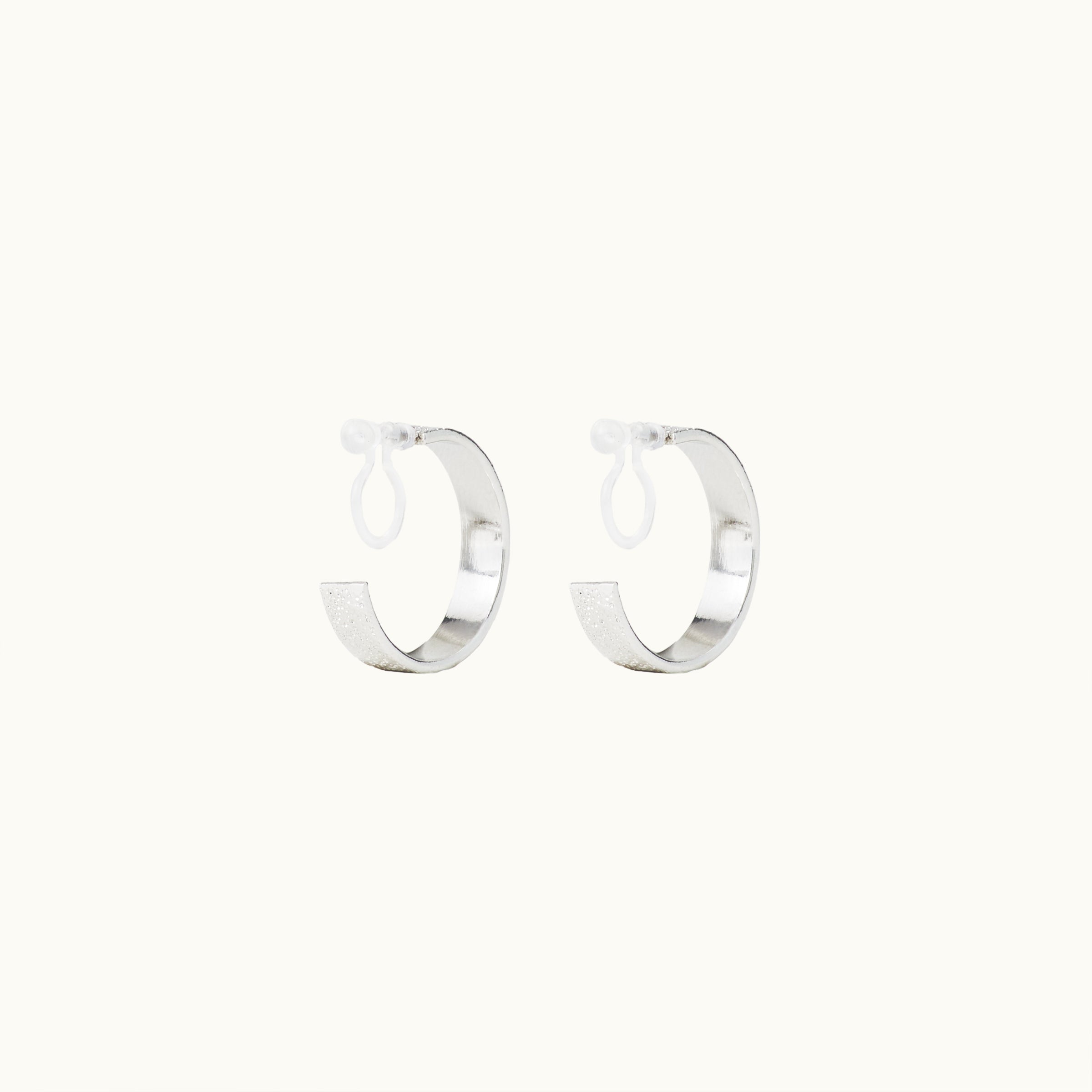 Image of the Speckled Hoop Clip On Earrings in Silver offer versatility and comfort for a range of ear sizes and sensitivities. With a medium secure hold, you can confidently wear them for 8-12 hours. Sold as a pair.