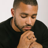 A model wearing the Straight Band Ring in Silver crafted from Stainless Steel, measuring 4mm in width, and featuring non-tarnish and water-resistant properties.
