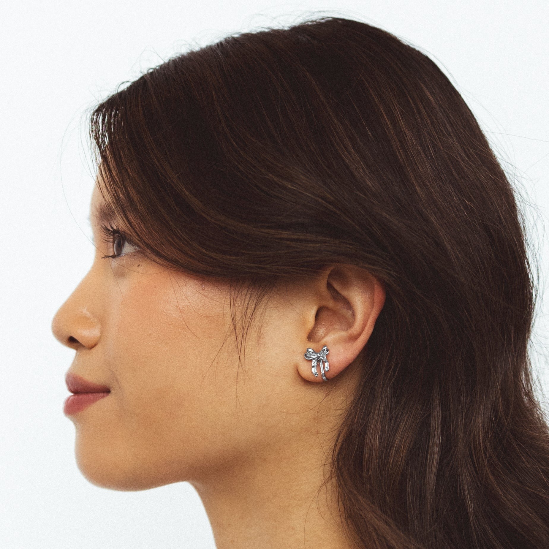 A model wearing the Taylor Clip On Earrings. Adjustable for sensitive or stretched ears, these earrings offer a 24-hour hold for effortless style at any occasion. Enjoy the perfect blend of elegance and ease with Taylor.