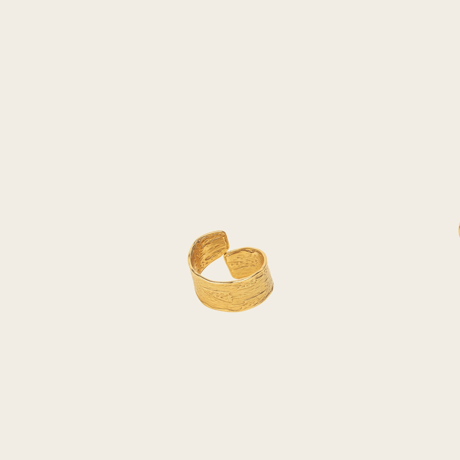 Image of the Textured Curl Ring in Gold is adjustable between sizes 7-10, crafted using 14K Gold Plated Stainless Steel for durability and resistance to tarnish, water, and lead, nickel, and cadmium. Please note that only one ring is included.