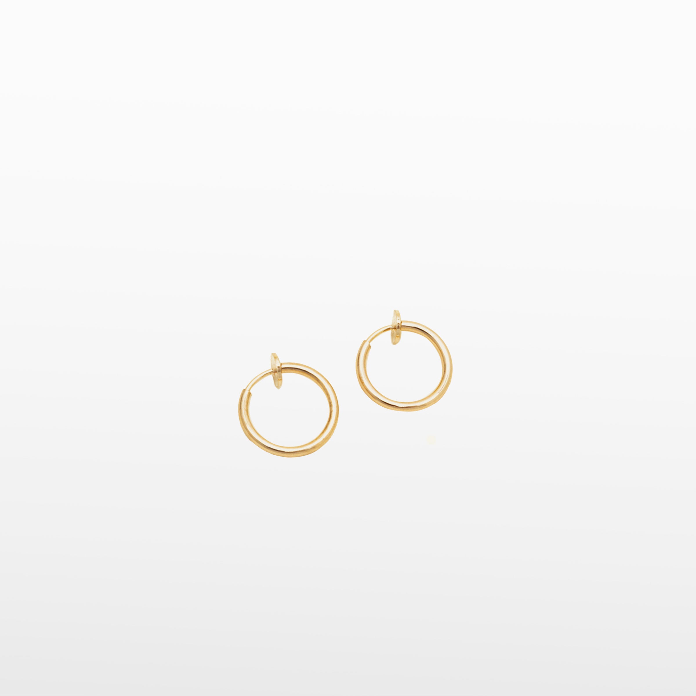 Image of the 18K Gold Plated Thin Hoop Clip On Earrings are ideal for those who have smaller, thinner ear lobes as the slide-spring closure makes them comfortable to wear for up to 4 hours. The earrings are highly secure and adjustable to fit any ear thickness. One pair is included.