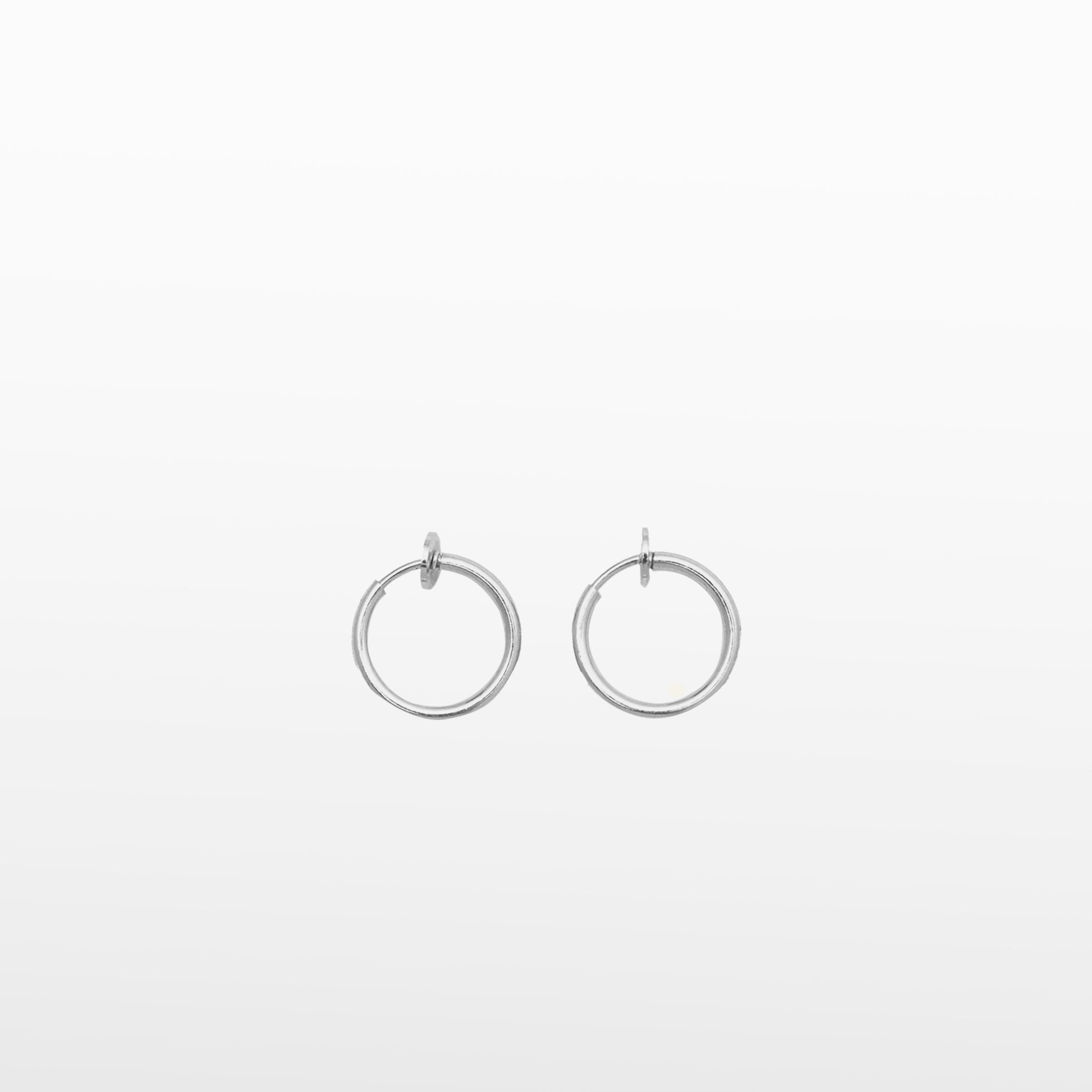 Image of the Thin Hoop Clip On Earrings in Silver feature an adjustable sliding spring closure, making them an ideal option for those with small or thin ear lobes. The secure hold strength and adjustable closure offer up to 4 hours of comfortable wear, ensuring a perfect fit no matter the ear thickness. Crafted from stainless steel, each earring is sold as part of a single pair.