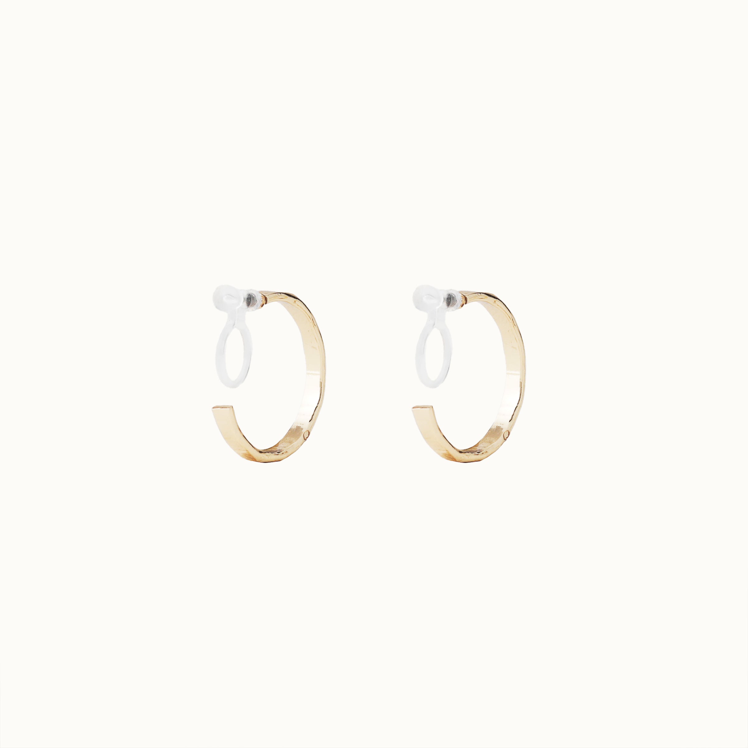 Image of the Tia Hoop Clip On Earrings in Gold are a must-have accessory. With a resin clip-on closure, they offer a secure hold for 8-12 hours of comfortable wear. Perfect for sensitive or small ears, and even those with thick or large ears. Please note, one pair included.