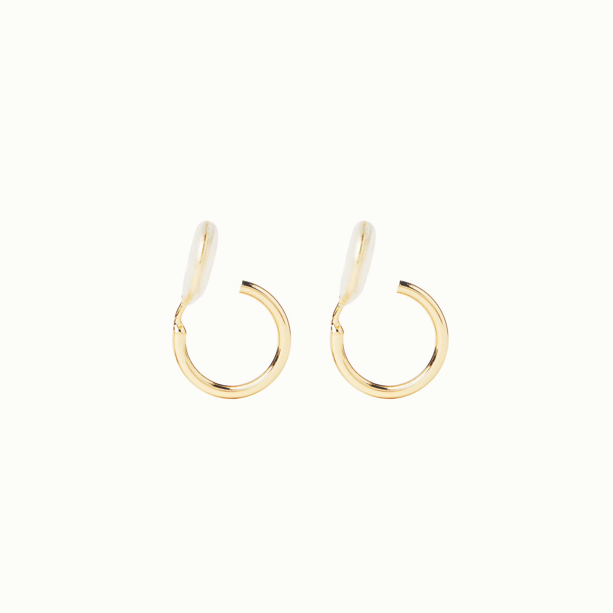 Image of the Tiny Hoop Clip On Earrings in Gold offer a Mosquito Coil Clip-On Closure, designed for comfort and versatility. Perfect for various ear types, they provide a secure hold and comfortable wear for 24 hours. 
