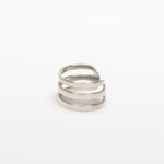 Image of the Triple Band Ear Cuff features a secure medium hold, adjustable fit, and non-tarnish, water-resistant stainless steel and titanium construction. Its 9mm diameter and 6mm width makes it ideal for all ear types, including thick/large, sensitive, small/thin, and stretched/healing ears. Average comfortable wear duration is up to 24 hours for one piece. Intended to be worn on the helix of the ear.