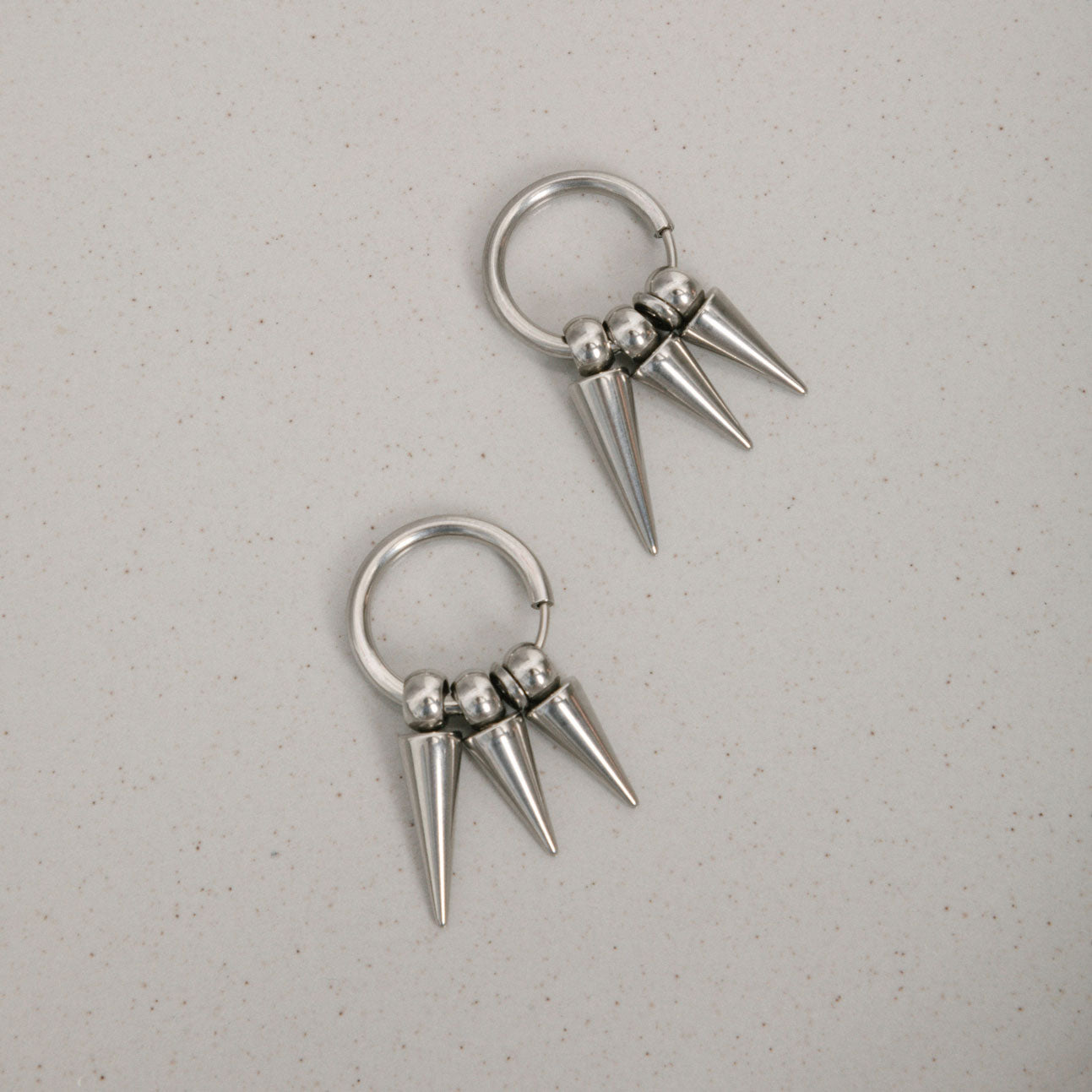 Image of the Triple Dangle Clip-On Earrings feature sliding spring closure, ideal for those with smaller or thinner ear lobes. Average comfortable wear duration estimated at 2 - 4 hours, with a secure hold. Earrings also have adjustable mechanism to ensure proper fit to ear thickness. Crafted with stainless steel, comes in one pair.