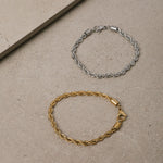 Image of the Twist Rope Chain Bracelet in Silver is crafted from non-tarnish and water-resistant stainless steel, with dimensions of 18 cm in length and 4 mm in width.