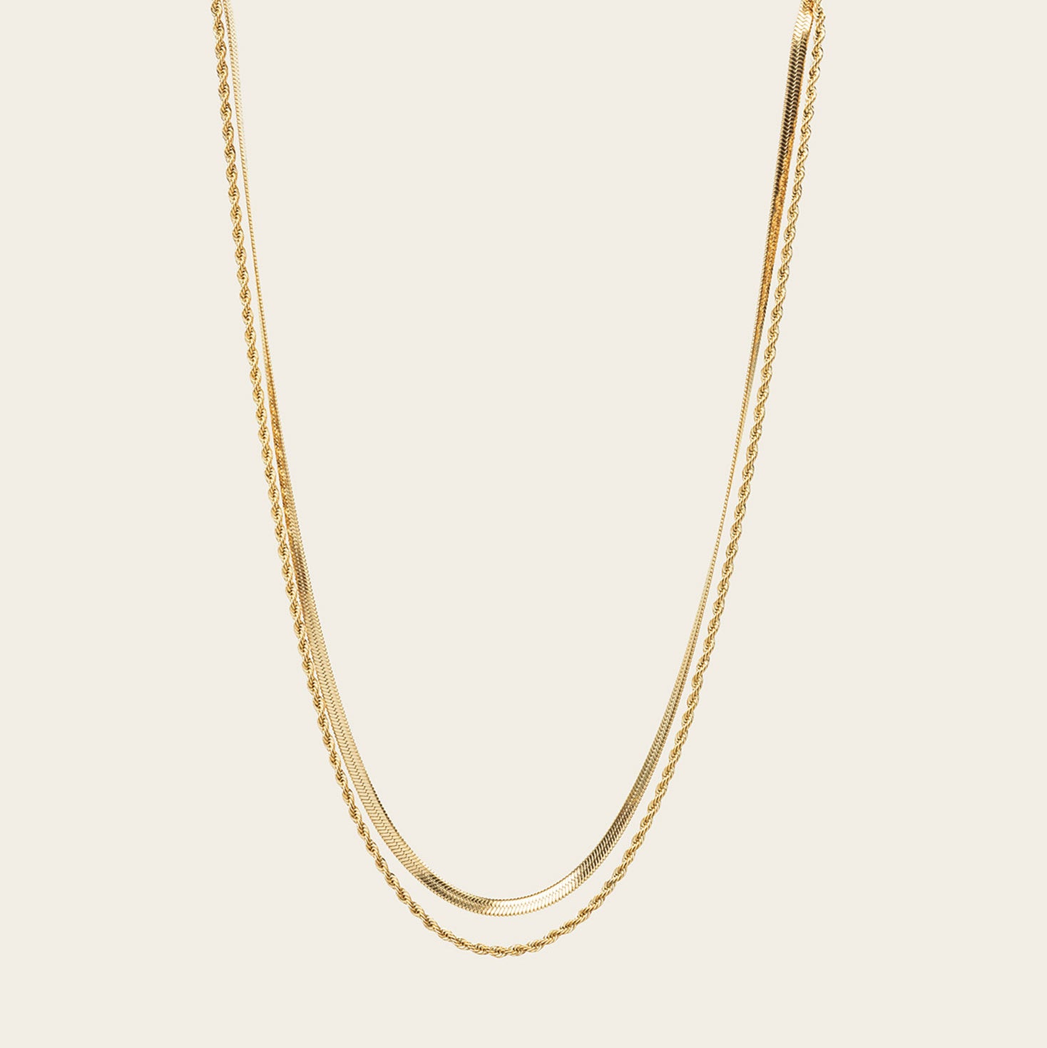 Image of the Twisted Double Layered Necklace consists of 14K Gold Plated Stainless Steel, providing water resistance, non-tarnishing, and leading, nickel, and cadmium free properties. Additionally, it is adjustable, though only one necklace is included.