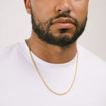 A model wearing the Twisted Rope Chain in Gold is crafted from thick 18K Gold Plated material. Dimensions are measured at 45cm, 50cm, or 55cm in length and 3mm in width. As an additional assurance, it is designed to be Allergy-free, Non-Tarnishable, and Water-resistant.