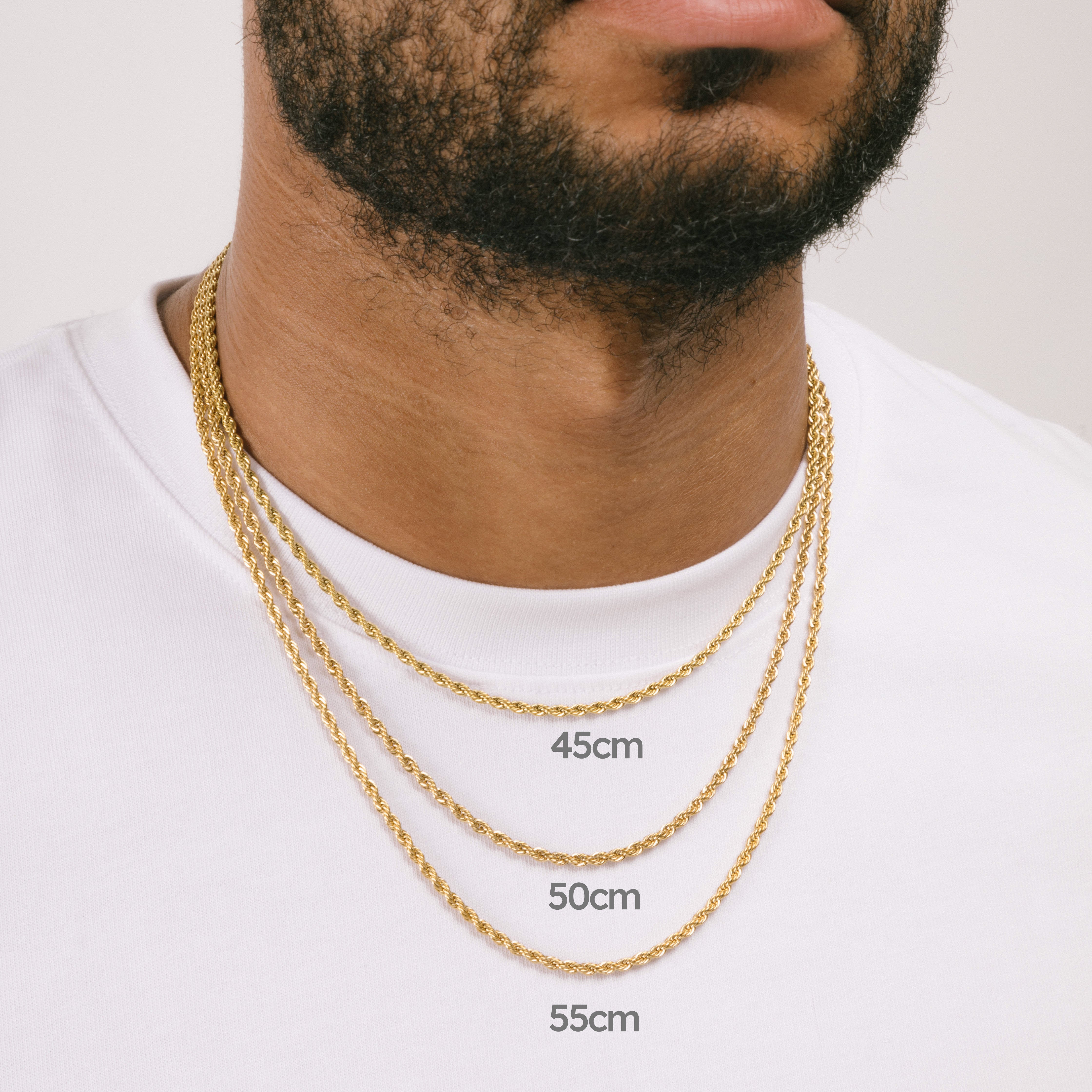 A model wearing the Twisted Rope Chain in Gold is crafted from thick 18K Gold Plated material. Dimensions are measured at 45cm, 50cm, or 55cm in length and 3mm in width. As an additional assurance, it is designed to be Allergy-free, Non-Tarnishable, and Water-resistant.