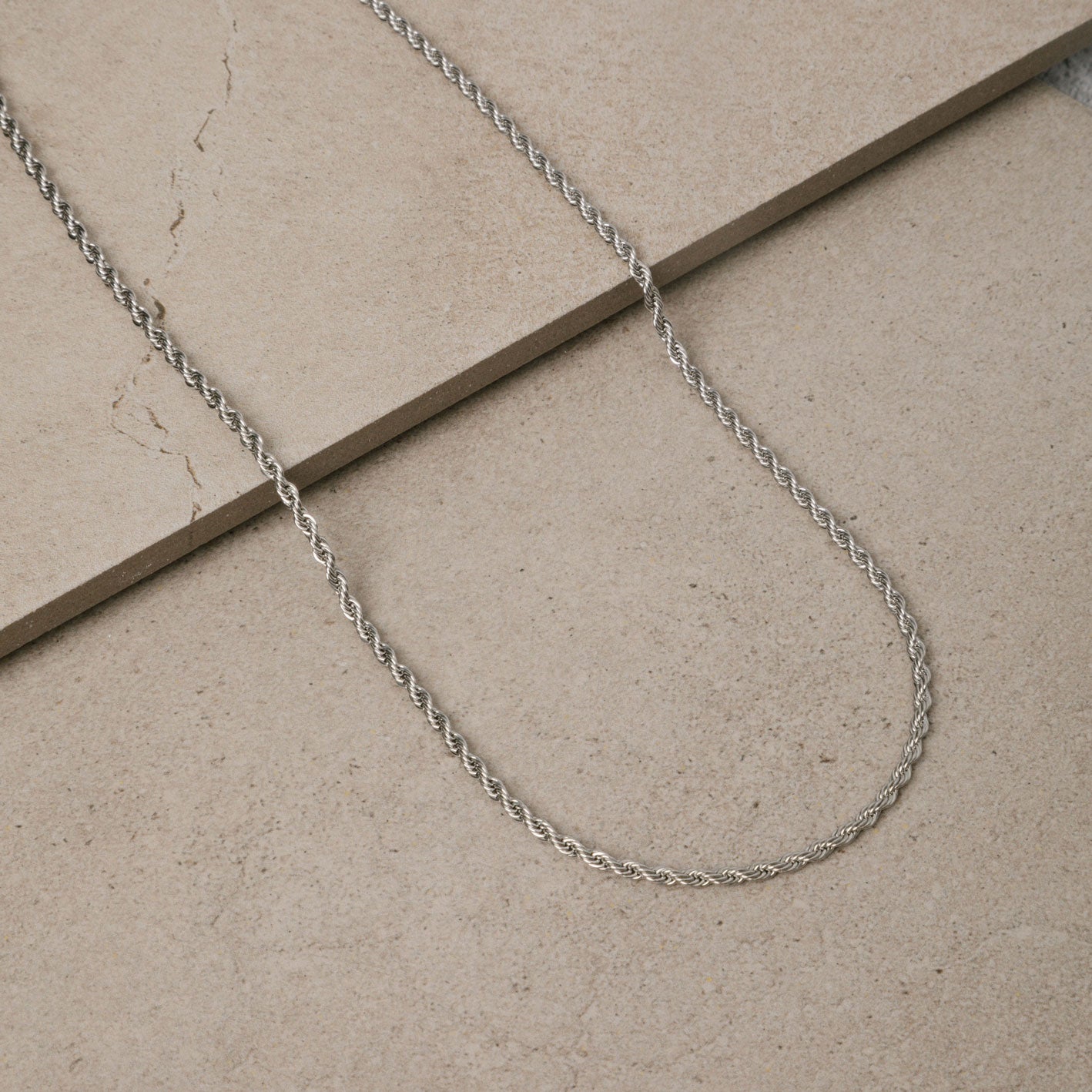 Image of the Twisted Rope Chain in Silver is crafted from durable stainless steel. It measures 45cm, 50cm, or 55cm in length and 3mm in width. Additionally, it is non-tarnishing, water-resistant, and safe for those with allergies.