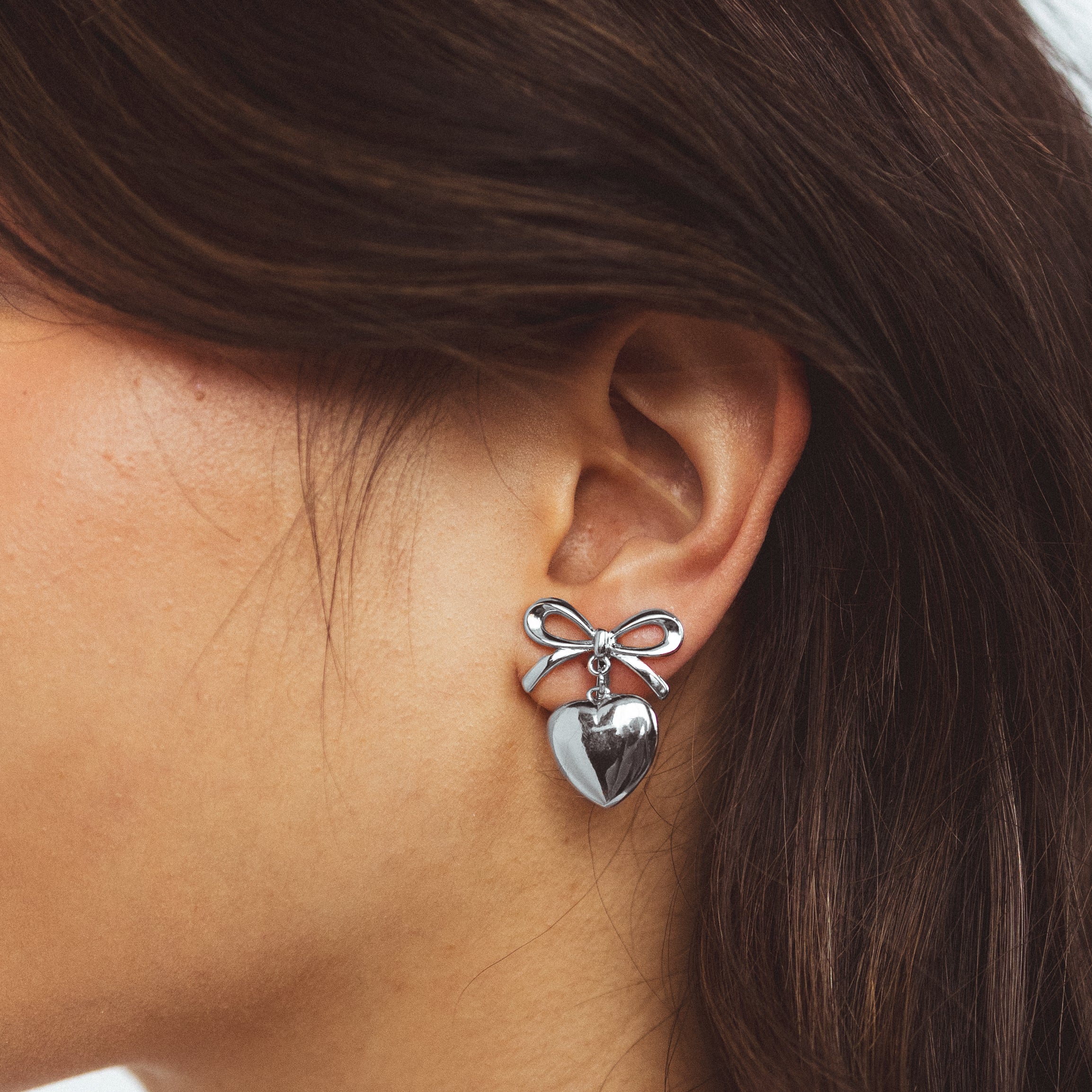 A model wearing the Venus Clip On Earrings. Specially designed for sensitive or stretched ears, these earrings ensure a secure 24-hour hold and customizable fit for unmatched comfort. Elevate your style with effortless elegance.