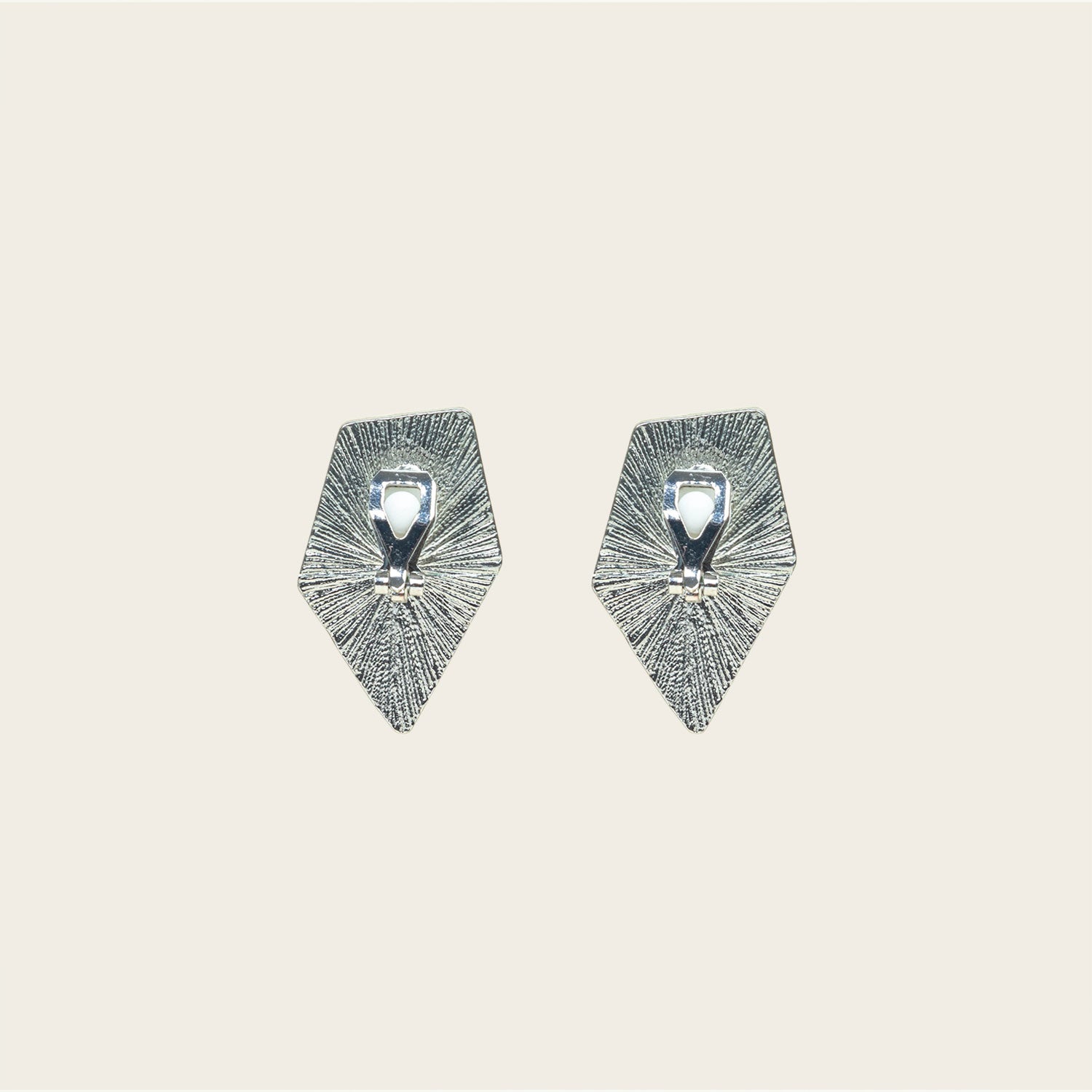 Image of the Vesper Clip On Earrings in Silver are padded clip-on earrings with a secure hold. Perfect for all ear types, they offer a comfortable wear for 8-12 hours. Made of zinc and copper alloy, the earrings come with a removable black rubber padding and can be worn as pictured. Please note, item is sold as one pair.