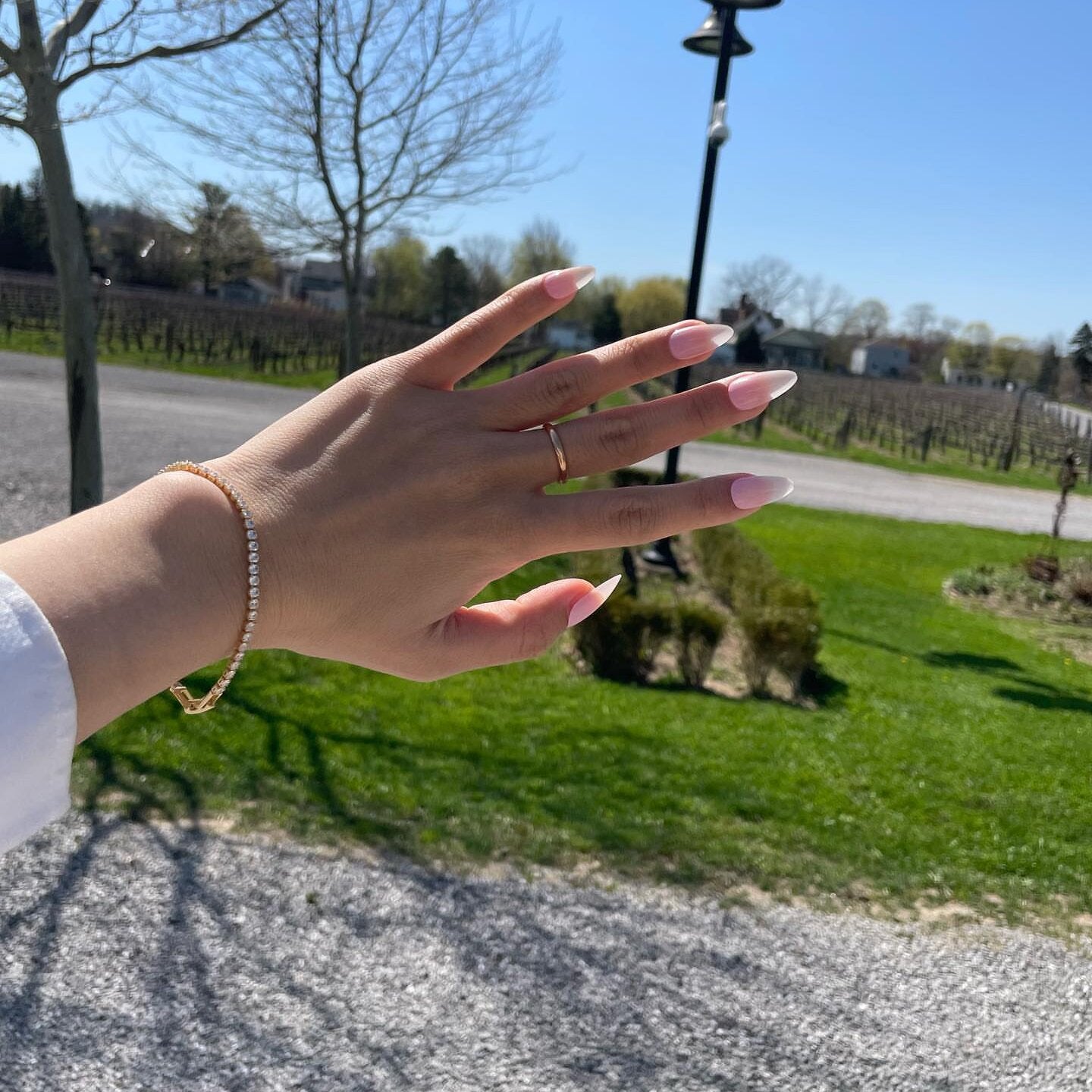 A model wearing the Tennis Bracelet is an exquisite companion to its sister piece, the Classic Tennis Necklace. Meticulously constructed from 14K gold plated metal, it is embellished with shimmering Cubic Zirconia stones. Additionally, its design is exceptionally enduring - it is tarnish-resistant, water-resistant, nickel-free, and hypoallergenic.